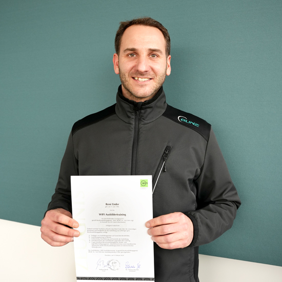 Warehouse manager Rene Ender holds his certificate