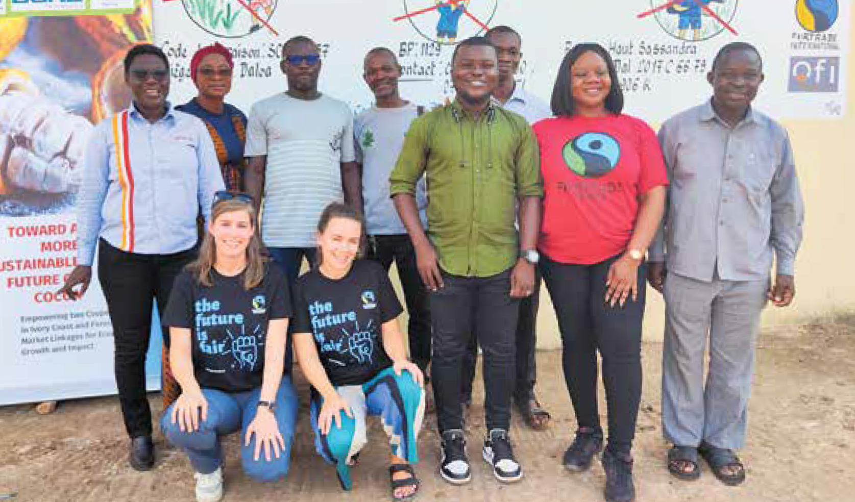 Fairtrade team with cocoa farmers in front of training poster