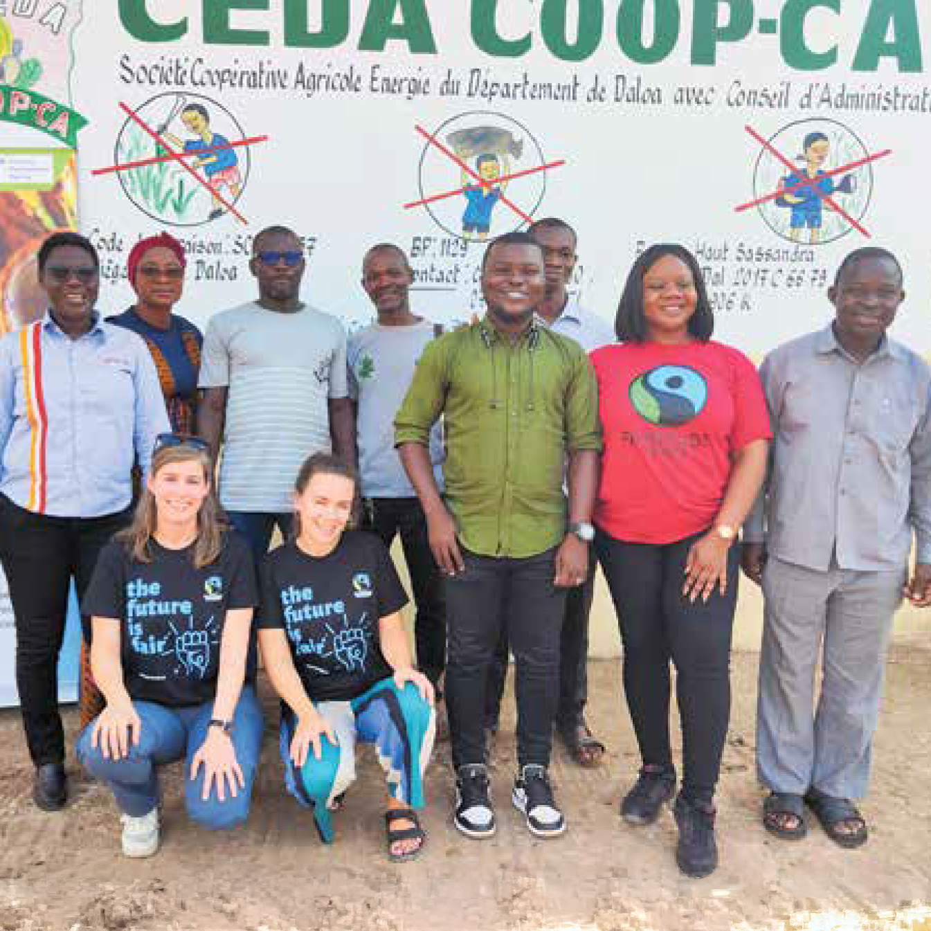 Fairtrade team with cocoa farmers in front of training poster