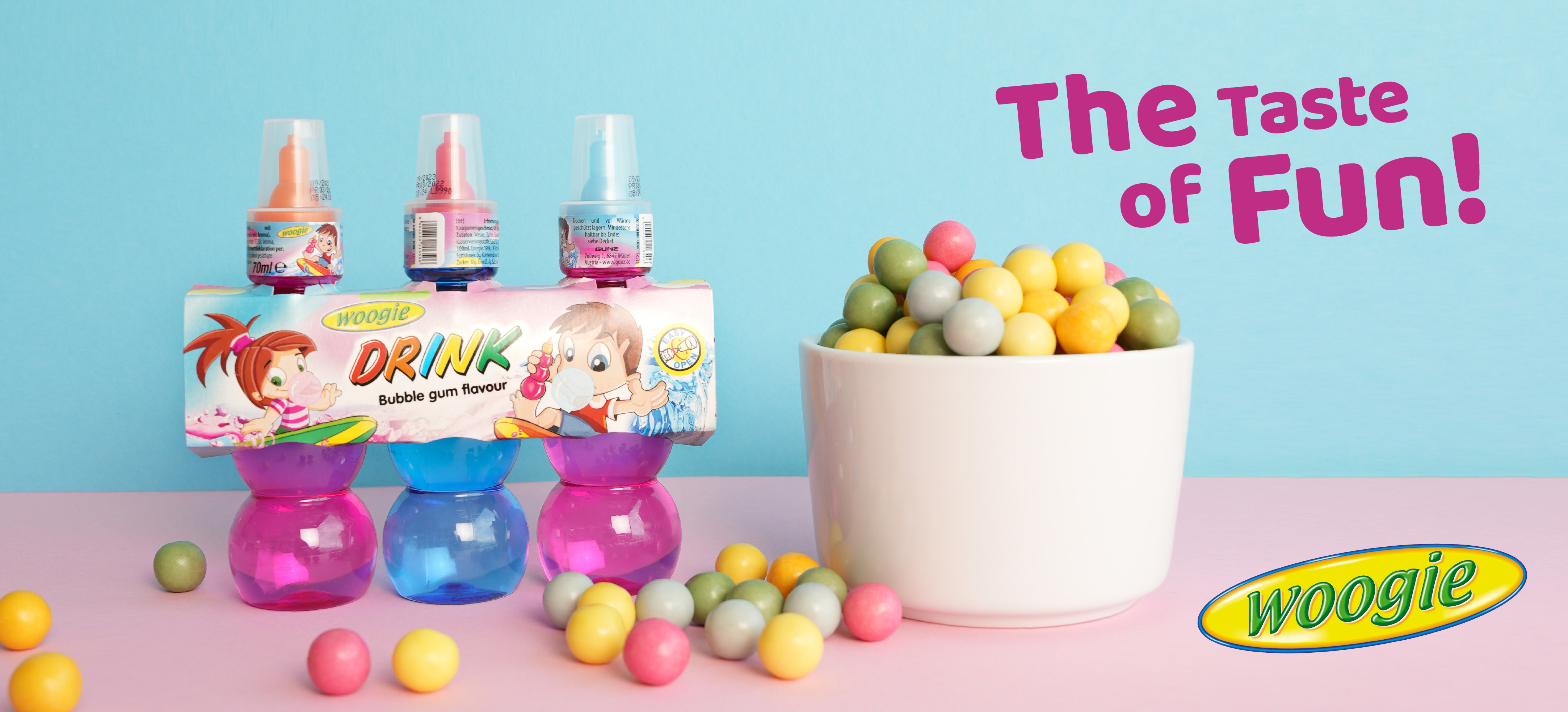 Woogie bubblegum drink in 3 bottles with gumballs & &ldquo;The Taste of Fun&rdquo; slogan